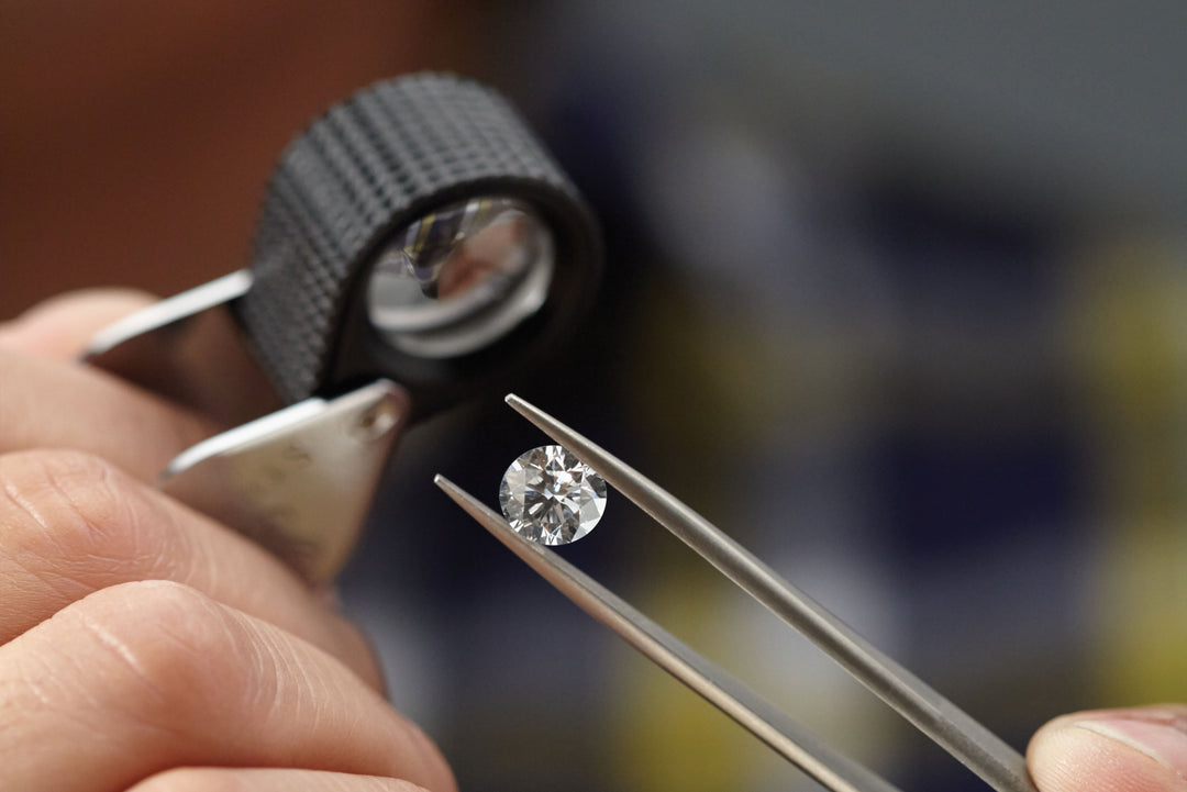 Jeweler examining a 2 carat lab-grown diamond for quality in New York City workshop