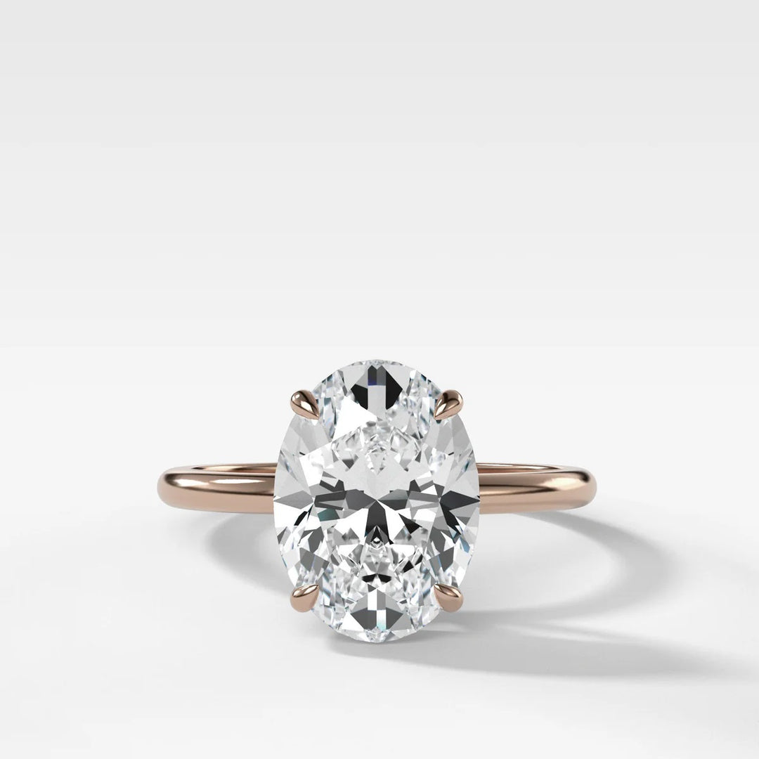 14k rose gold oval solitaire engagement ring with 2.50ct lab-grown diamond, showing warm metal tone and thin band