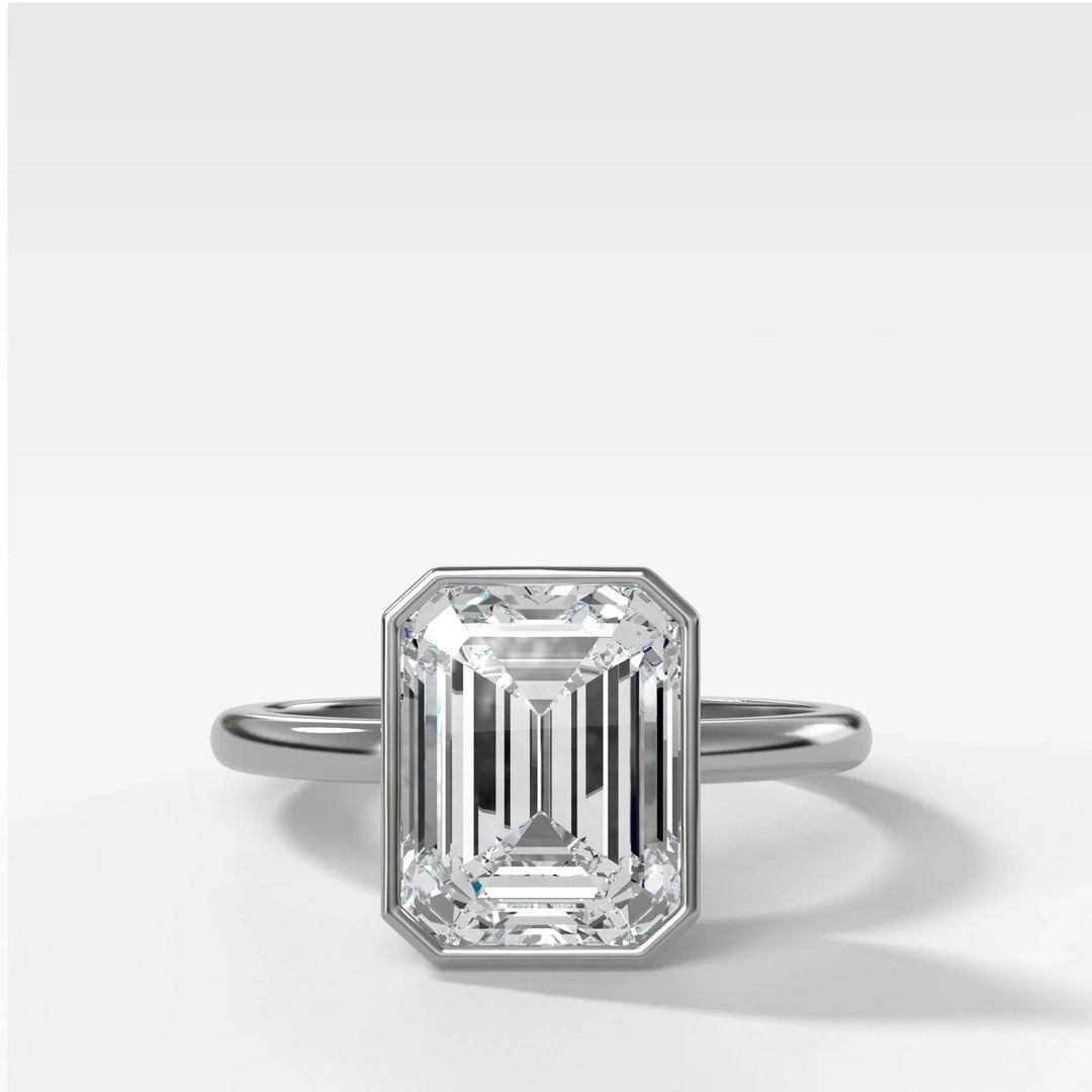 Platinum bezel set engagement ring with emerald cut lab-grown diamond, handcrafted in New York Diamond District