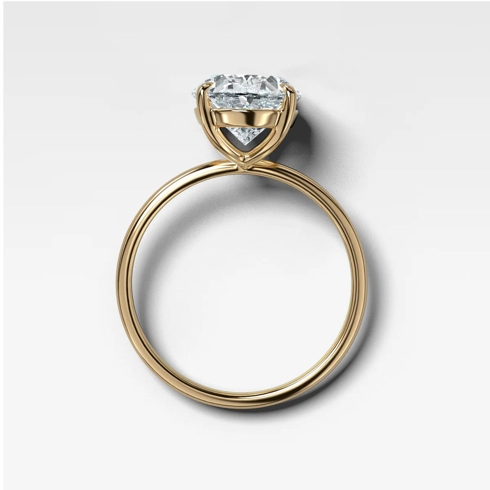 Side profile view of oval solitaire engagement ring showing 4-prong eagle claw setting and whisper thin band structure made in New York